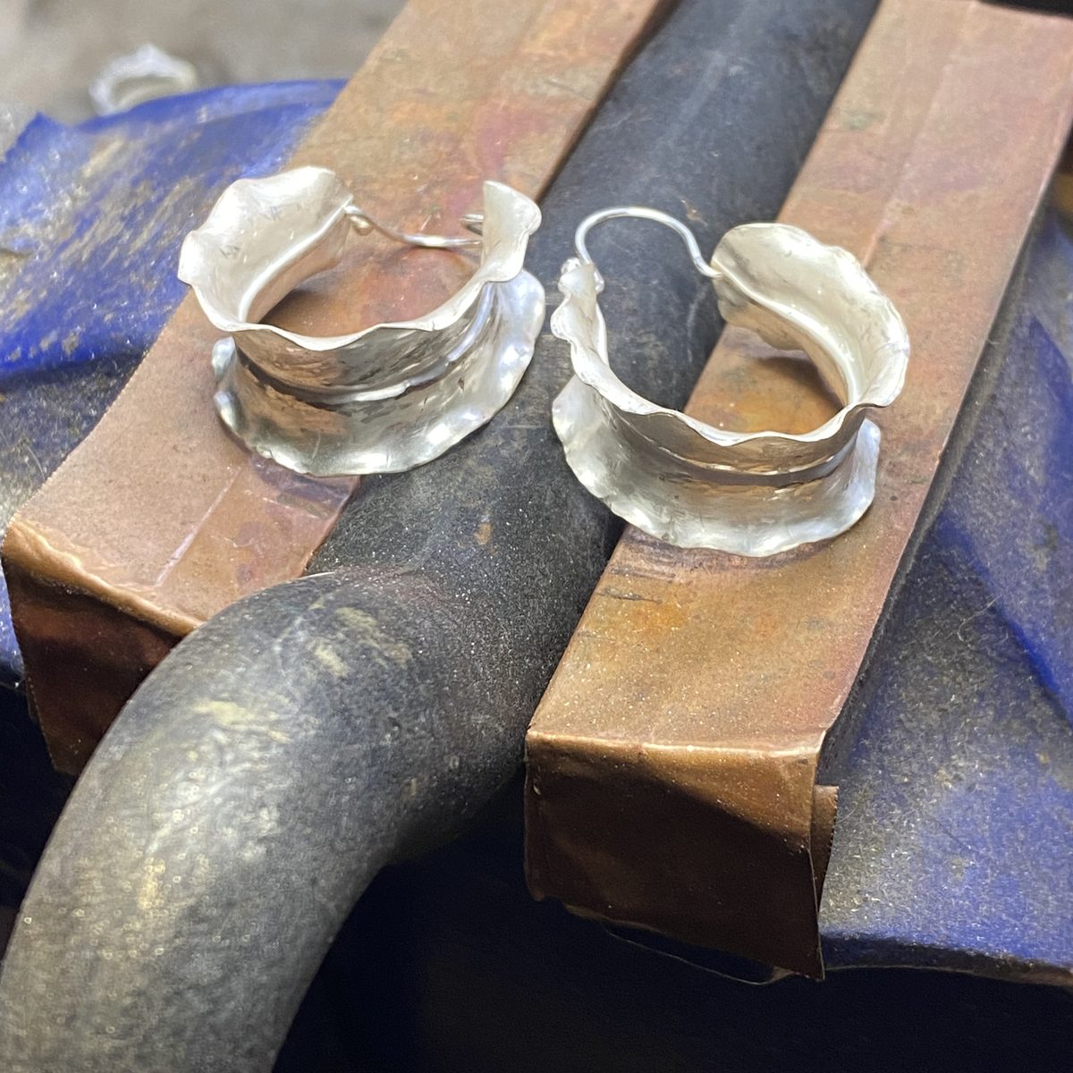 Fluted silver hoop earrings at the bench